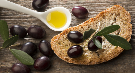 Olive oil and olives on the wooden table