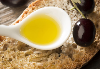 Olive oil and olives on the wooden table