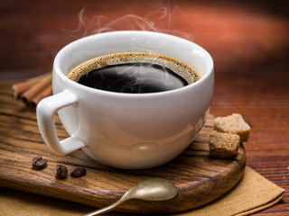 Cup of coffee and cane sugar cubes.