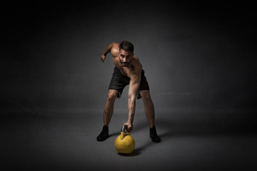 man with kettleball on hand