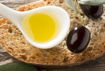 Olive oil and olives on the wooden table