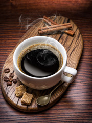 Cup of coffee and cane sugar cubes.