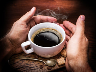 Cup of coffee and cane sugar cubes.