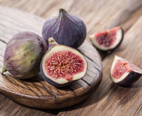 Ripe fig fruits on the wooden table.