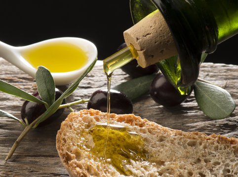 Olive oil and olives on the wooden table