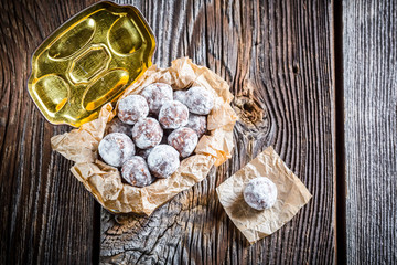Sweet cocoa balls with powder milk in old box