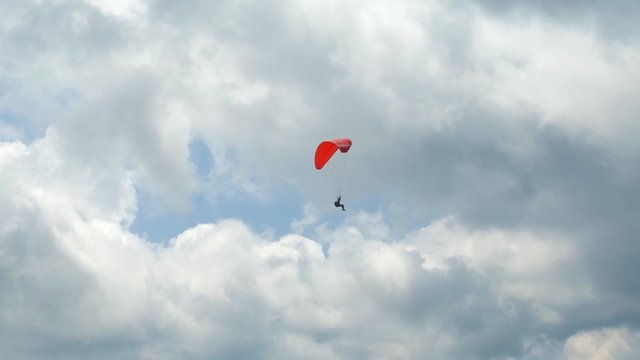 4k,
Paraglider flying high in the mountains