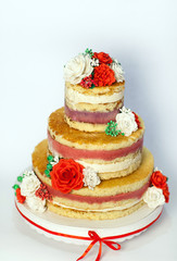 Wedding cake. Naked handmade cake rustic, decorated with roses.