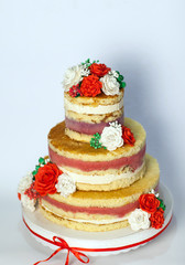 Wedding cake. Naked handmade cake rustic, decorated with roses.