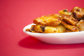 Octopus with paprika on a white plate, also known as Galician oc