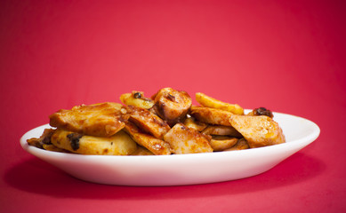 Octopus with paprika on a white plate, also known as Galician oc