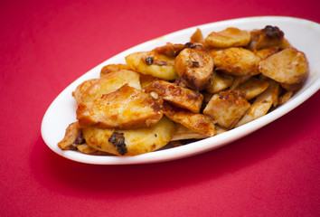 Octopus with paprika on a white plate, also known as Galician oc