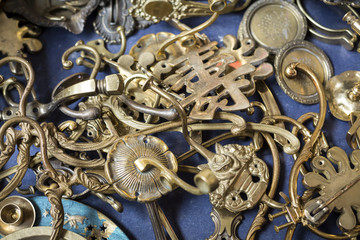 bunch of many old brass door mountings on a flea market
