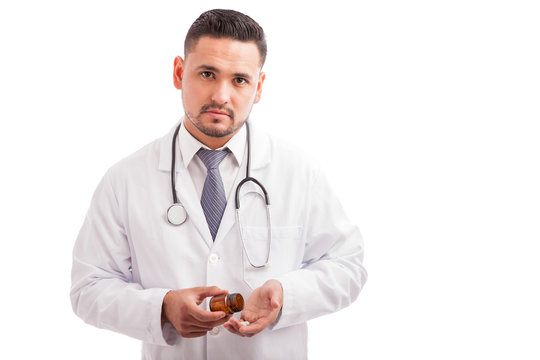 Doctor taking some pills from a bottle