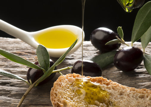 Olive oil and olives on the wooden table