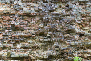 old dilapidated brick wall .