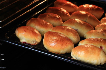 Homemade cakes with jam are baked in the oven