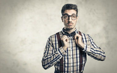 Funny portrait of young nerd with eyeglasses isolated on background - obrazy, fototapety, plakaty