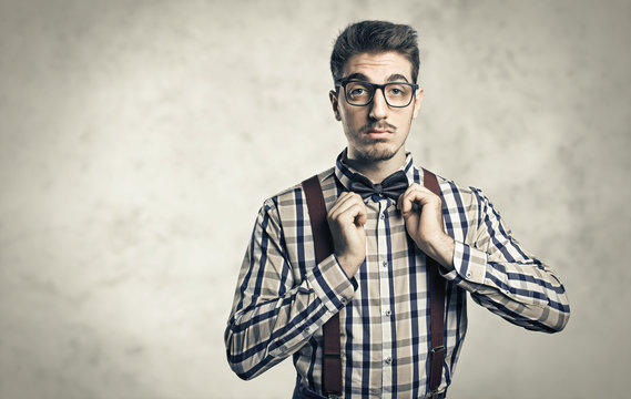 Funny portrait of young nerd with eyeglasses isolated on background
