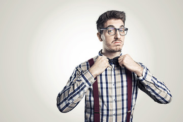 Funny portrait of young nerd with eyeglasses isolated on background