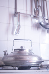 Kitchen utensils and kettle on gas stove