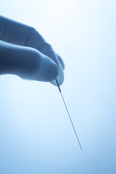 Doctor hand acupuncture needle dry needling