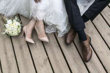 feet of bride and groom, wedding shoes (soft focus). Cross proce - Powered by Adobe