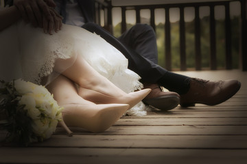 feet of bride and groom, wedding shoes (soft focus). Cross proce