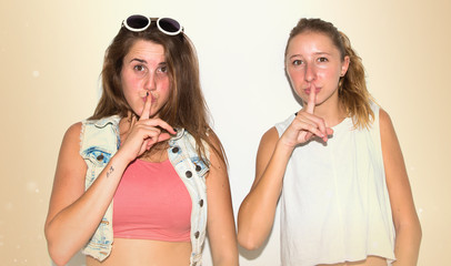 Girls making silence gesture