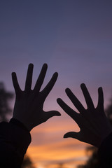 Fingers of hands at dusk silhouette sunset sky