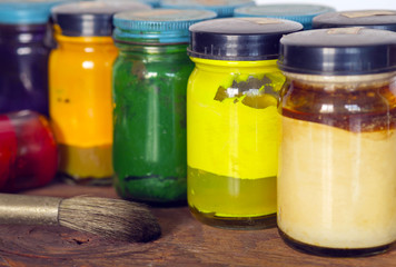 Oil Paint with paintbrush/Oil Paint with paintbrush on wood background, selected focus on yellow bottle.