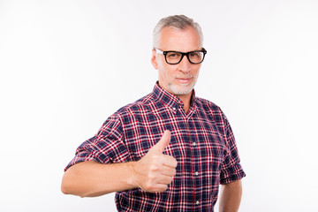 Gray aged man with glasses gesturing thumb up