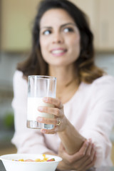 Attractive young woman drinking milk