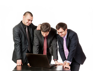 Three businessmen near laptop on business talk