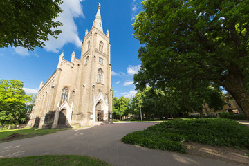 Old christian church in park at summer.