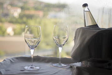 Glasses and bottle of water in metal ice bucket