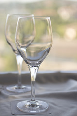 Wine or water glasses on coasters on cloth on tray