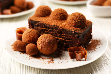 Slices of chocolate cake with a truffle on plate closeup