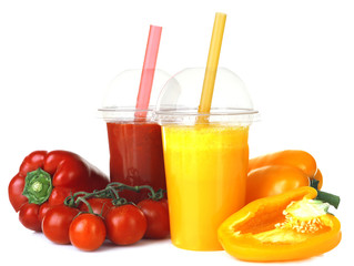 Fresh vegetable juices in plastic cups isolated on white