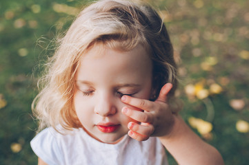 portrait of a little blond girl outdoors