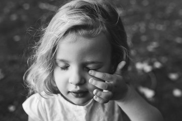 portrait of a little blond girl outdoors
