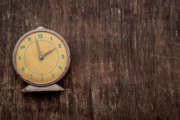 Vintage background with retro alarm clock on table