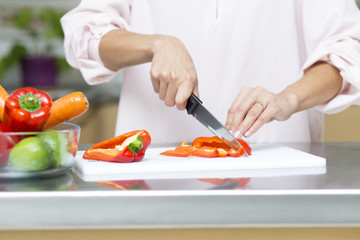 Closeup on woman cutting fresh vegetables