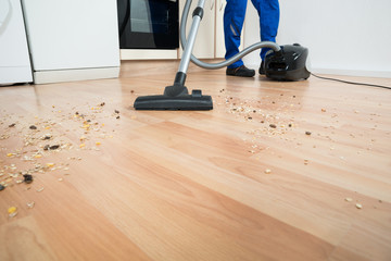 Janitor Cleaning Floor With Vacuum Cleaner