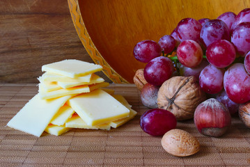 Fototapeta na wymiar Cheese and grapes on a board