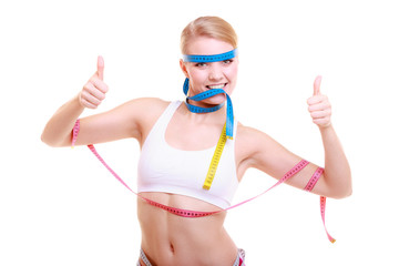 Obsessed fitness woman with a lot of colorful measure tapes