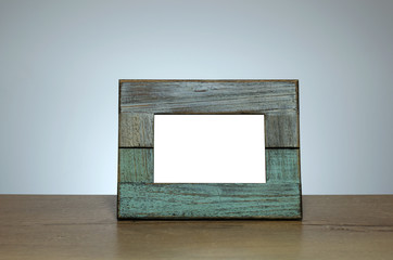 Old wooden photography frame on the table. Space for text or photo provided