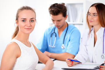 Happy patient and two doctors