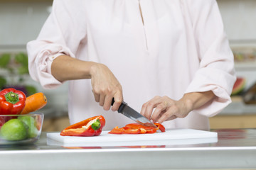 Closeup on woman cutting fresh vegetables