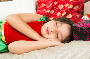Obraz na płótnie Canvas Little girl sleeping next to Christmas present